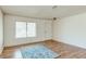 Bright living room with hardwood floors and natural light from a window at 4916 Carmichael Ave, Las Vegas, NV 89110