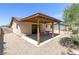 Covered backyard patio with gravel landscaping and a table and chairs at 4916 Carmichael Ave, Las Vegas, NV 89110