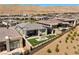 An aerial view of the property showcases artificial grass, a fire pit, a covered patio with seating at 5166 Stone View Dr, Las Vegas, NV 89135