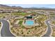 Aerial view showcases the community pool, clubhouse, and surrounding desert landscape at 5166 Stone View Dr, Las Vegas, NV 89135
