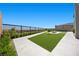 Spacious backyard with manicured lawn, a fire pit area, and a view of the surrounding neighborhood at 5166 Stone View Dr, Las Vegas, NV 89135