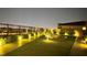 Night view of the private backyard with a modern fire pit, turf, and city view at 5166 Stone View Dr, Las Vegas, NV 89135