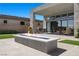 Beautiful backyard with a modern fire pit, outdoor seating, and manicured landscaping at 5166 Stone View Dr, Las Vegas, NV 89135