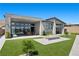 Modern backyard features a cozy fire pit, artificial grass, and sliding doors into the home at 5166 Stone View Dr, Las Vegas, NV 89135
