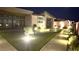 Outdoor living featuring manicured lawn, tasteful lighting, and modern architectural details at 5166 Stone View Dr, Las Vegas, NV 89135