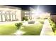 Beautifully landscaped backyard featuring artificial grass, a modern patio, and an inviting outdoor lounge area at 5166 Stone View Dr, Las Vegas, NV 89135