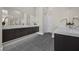 Spacious bathroom featuring dual vanities with marble countertops and modern fixtures at 5166 Stone View Dr, Las Vegas, NV 89135