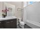 Bright bathroom with a large mirror, modern vanity, and bathtub with a shower curtain at 5166 Stone View Dr, Las Vegas, NV 89135