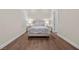 Minimalist bedroom design with hardwood flooring, bright lighting, and modern style at 5166 Stone View Dr, Las Vegas, NV 89135