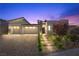 Stunning modern home with a three-car garage, beautiful landscaping, and a welcoming front entrance at 5166 Stone View Dr, Las Vegas, NV 89135