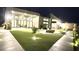 A modern home featuring a spacious patio, artificial grass, fire pit, and ample outdoor seating at 5166 Stone View Dr, Las Vegas, NV 89135