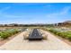 Outdoor fire pit surrounded by seating overlooking a scenic desert community and pond at 5166 Stone View Dr, Las Vegas, NV 89135