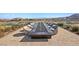 Outdoor firepit with large table, surrounded by chairs, and views of mountains in the distance at 5166 Stone View Dr, Las Vegas, NV 89135