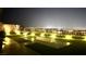 Outdoor fire pit with adjacent artificial turf providing a tranquil view of the city at 5166 Stone View Dr, Las Vegas, NV 89135