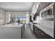 Open kitchen with stainless steel appliances, a large center island, and abundant natural light at 5166 Stone View Dr, Las Vegas, NV 89135