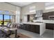 Open concept kitchen with bar seating and a seamless transition from the indoor to outdoor space at 5166 Stone View Dr, Las Vegas, NV 89135