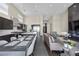 Open-concept layout with modern kitchen, dining area, and living room with fireplace and designer accents at 5166 Stone View Dr, Las Vegas, NV 89135
