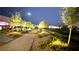 Night view of illuminated pathway with manicured landscaping, trees, and flowers at 5166 Stone View Dr, Las Vegas, NV 89135