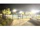 Community pool area at night behind a wrought iron fence with a paved entry and desert landscaping at 5166 Stone View Dr, Las Vegas, NV 89135