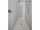 Contemporary shower boasting hexagon-shaped tile floor, shower head and marble tile walls at 5166 Stone View Dr, Las Vegas, NV 89135