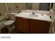 Bathroom featuring a vanity with a single sink, a mirror, and a toilet at 5308 La Quinta Hills St, North Las Vegas, NV 89081