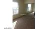 Bedroom with sliding mirror closet doors and natural light coming through the windows at 5308 La Quinta Hills St, North Las Vegas, NV 89081