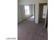 Bedroom featuring a mirrored closet and an open door, offering ample storage and natural light at 5308 La Quinta Hills St, North Las Vegas, NV 89081
