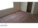 Bedroom featuring carpet flooring, natural light and a door leading to another room at 5308 La Quinta Hills St, North Las Vegas, NV 89081