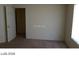 Bedroom with an open door to a hallway and a large blank wall, perfect for personalization at 5308 La Quinta Hills St, North Las Vegas, NV 89081