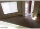 Entryway with an open white door to the exterior showing neutral exterior paint, tan carpet and tile at 5308 La Quinta Hills St, North Las Vegas, NV 89081