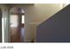 Open entryway with tile flooring and partial view into the living area and staircase at 5308 La Quinta Hills St, North Las Vegas, NV 89081