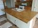Close up of a kitchen island featuring granite countertops and a double sink at 5308 La Quinta Hills St, North Las Vegas, NV 89081