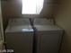 A well-lit laundry room features a white washer and dryer set at 5308 La Quinta Hills St, North Las Vegas, NV 89081