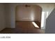 Living room with beige carpet, neutral walls and tile floors, and an arched doorway at 5308 La Quinta Hills St, North Las Vegas, NV 89081