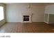 Spacious living room with tile flooring, fireplace, and neutral walls bathed in natural light at 5308 La Quinta Hills St, North Las Vegas, NV 89081