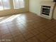 Bright living room with large windows, tile flooring, and fireplace with white mantle at 5308 La Quinta Hills St, North Las Vegas, NV 89081