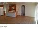 Open living space with a view of the kitchen, tile floors, and natural light throughout at 5308 La Quinta Hills St, North Las Vegas, NV 89081