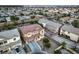 Aerial view of a two-story home with a brick-red roof, a two-car garage, and green landscaping at 5480 Oatfield St, North Las Vegas, NV 89081