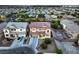 Aerial view of a two-story home with a brick-red roof, a two-car garage, and green landscaping at 5480 Oatfield St, North Las Vegas, NV 89081