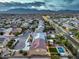 Aerial view of suburban neighborhood with many houses, streets and green landscaping at 5480 Oatfield St, North Las Vegas, NV 89081