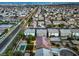 An aerial view of a residential neighborhood showcases well-maintained homes, streets, and city lights in the distance at 5480 Oatfield St, North Las Vegas, NV 89081