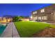 Large backyard with pool, artificial grass, and patio area, ideal for outdoor entertaining at 5480 Oatfield St, North Las Vegas, NV 89081