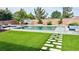 Backyard featuring a swimming pool, lush lawn, privacy fence, and patio area at 5480 Oatfield St, North Las Vegas, NV 89081