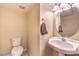 Cozy powder bathroom with a pedestal sink and decorative mirror at 5480 Oatfield St, North Las Vegas, NV 89081