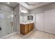 Bright bathroom with a glass enclosed shower and dual closets at 5480 Oatfield St, North Las Vegas, NV 89081