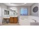 Bathroom with double sinks, soaking tub, and a large window at 5480 Oatfield St, North Las Vegas, NV 89081