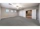 Large bedroom with gray carpet, ceiling fan and an open double door at 5480 Oatfield St, North Las Vegas, NV 89081