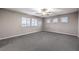 Spacious bedroom with neutral walls, carpet, and a ceiling fan at 5480 Oatfield St, North Las Vegas, NV 89081