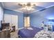 Comfortable bedroom featuring carpet, fan, closet, and study desk area with white shelving and decor at 5480 Oatfield St, North Las Vegas, NV 89081