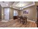 Bright dining room with wood floors and elegant chandelier at 5480 Oatfield St, North Las Vegas, NV 89081
